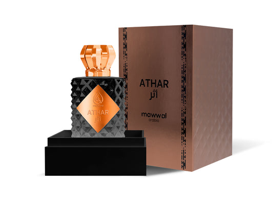 Athar Eau de Parfum bottle and box with black and copper design, showcasing elegant fragrance packaging.